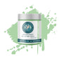 Jar of artisan paint with a green splash on a white background