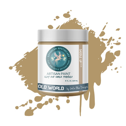 A jar of Earthy Brown Clay and Chalk Paint labeled 'Saddle Up' by Daydream Apothecary with a paint splatter behind it 